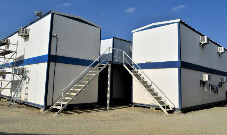 Two-storey portable modular accommodation buildings with external staircases.
