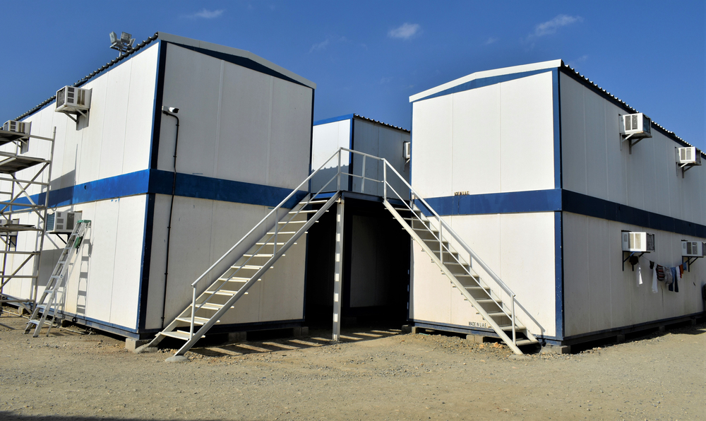 Two-storey portable modular accommodation buildings with external staircases.